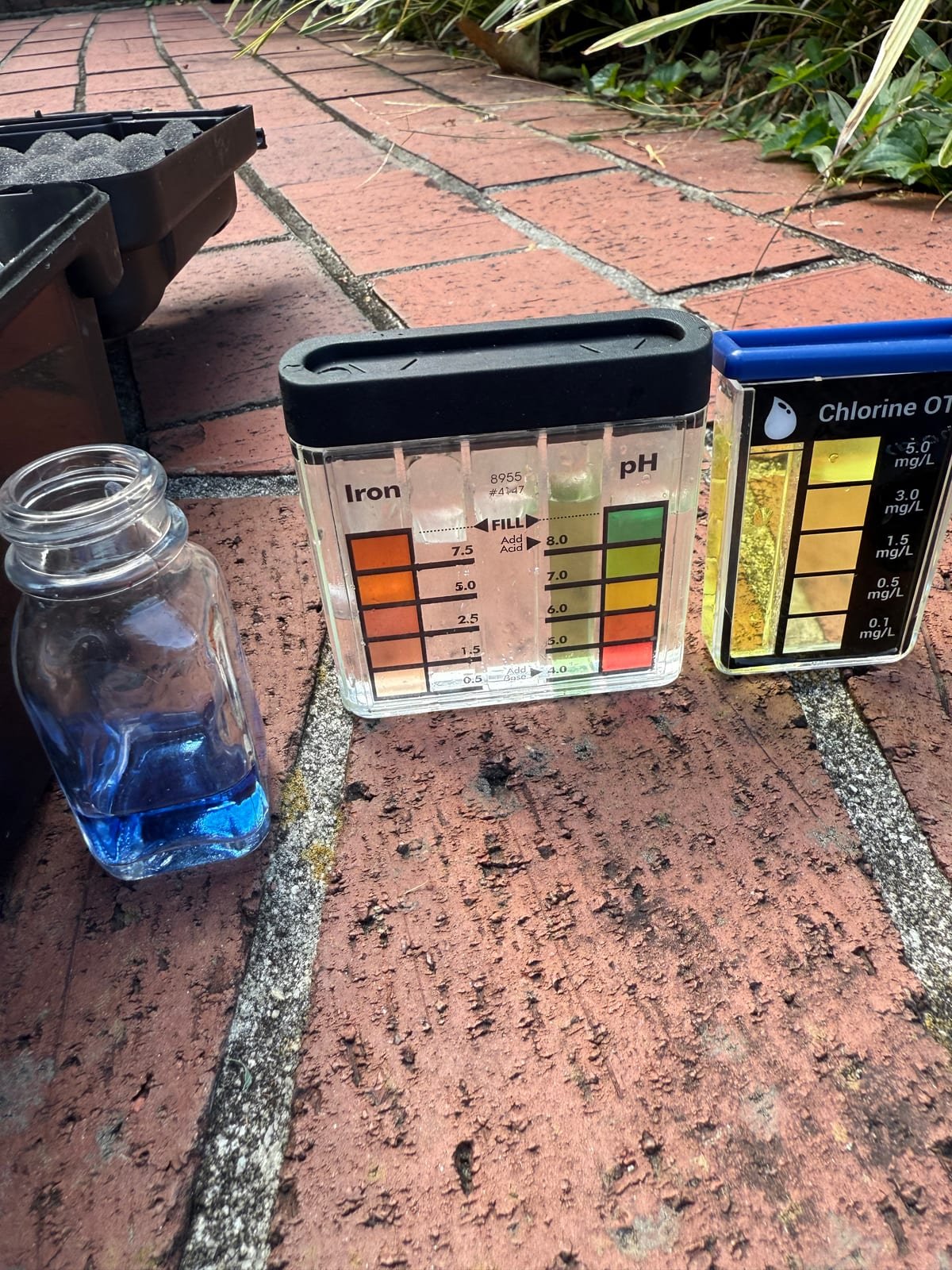Water quality test samples showing results for hardness, chlorine, iron and pH